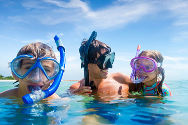 Family snorkeling in Bahamas