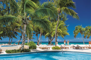 Couple walking on beach at Sandals Resort