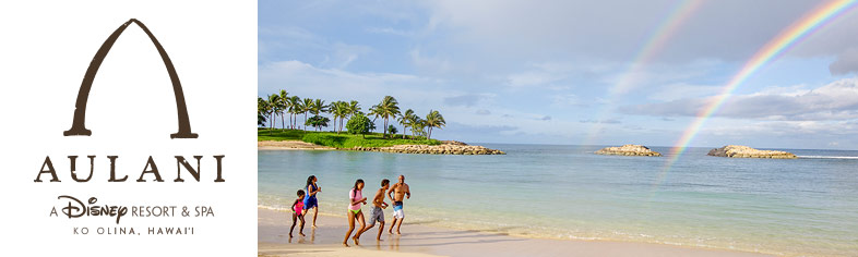 Family running on beach with rainbow