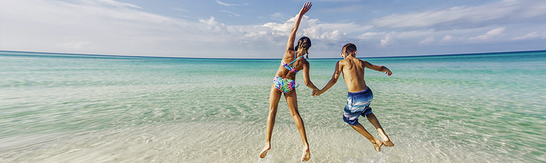 Kids jumping on beach in Florida