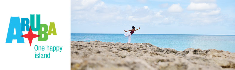 Woman doing yoga on Aruba beach