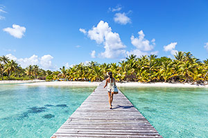 Woman walking on dock in Tikehau Atoll