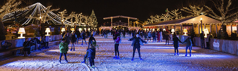 Ice skaters at night in European Christmas Market
