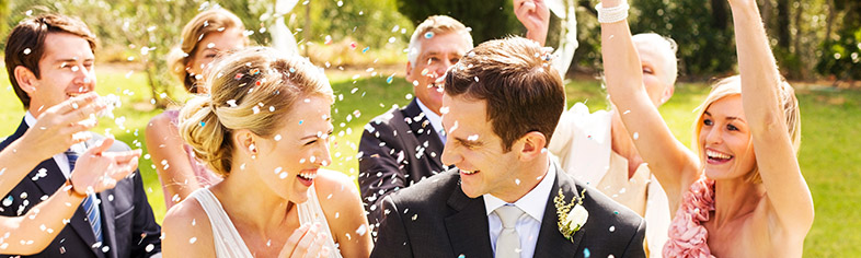 People throwing rice at wedding