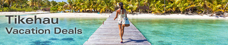 Woman walking on dock in Tikehau, Tahiti
