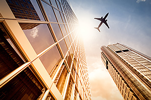 Airplane flying past buildings