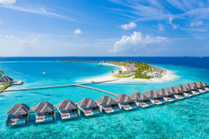 Maldives - aerial view of atoll and overwater bungalows